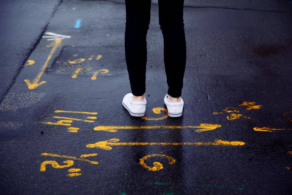person standing on marked concrete with arrows