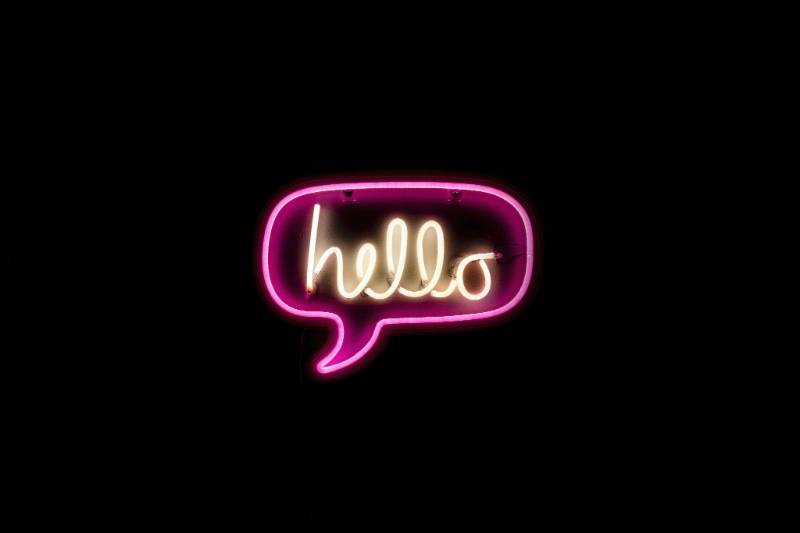 Neon sign with the word hello in cursive