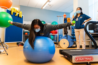 student testing balance on a bosu ball with weights